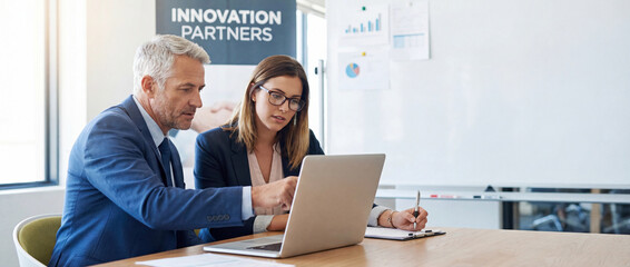 Two professional business people working together. Partners mature man and woman discussing project in office. Team leader explain trainee working process using tablet pc computer. Banner, copy space