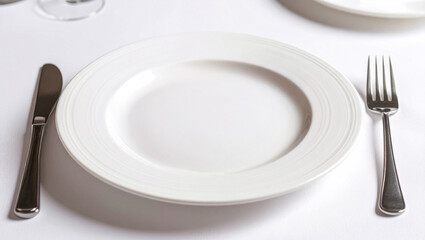 Empty White Plate on Tablecloth with Silverware