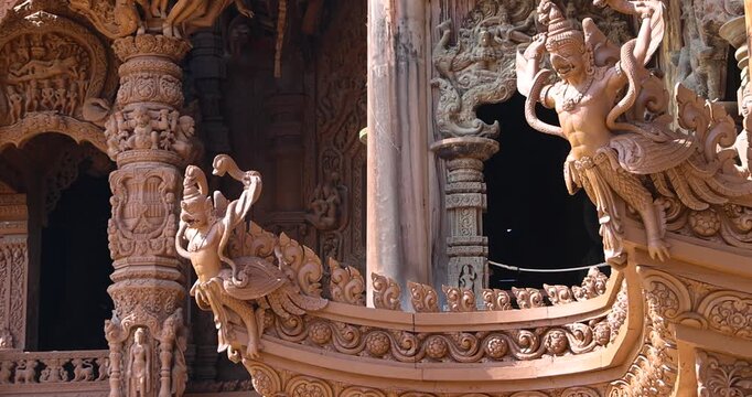 Intricate exterior wooden architecture of Hindu gods on Sanctuary of Truth temple in Pattaya city, Thailand