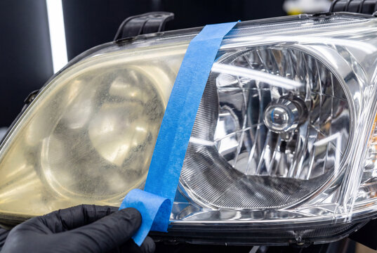 Before and after result of car headlight restoration separated by blue tape being peeled off