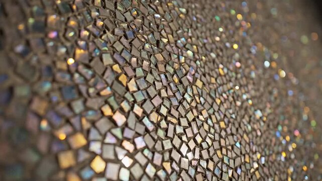 Close-up of a textured mosaic wall with iridescent square tiles shimmering with rainbow light effects and soft bokeh highlights creating a dazzling and abstract background