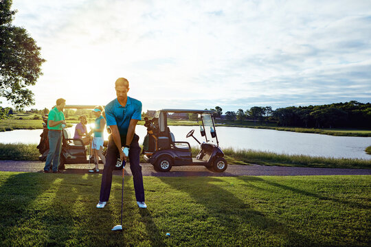 Golf, man or playing on field with people for morning fitness, competition match or sport hobby. Sunrise, golfer club or player with swing stance on course for stroke practice, game exercise or space