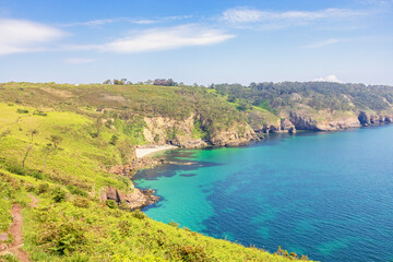 Footpath by a rocky coast in an awesome view with turquoise water in a bay