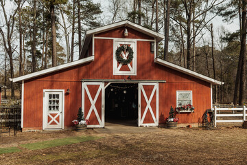 Red barn with festive wreaths © Cavan