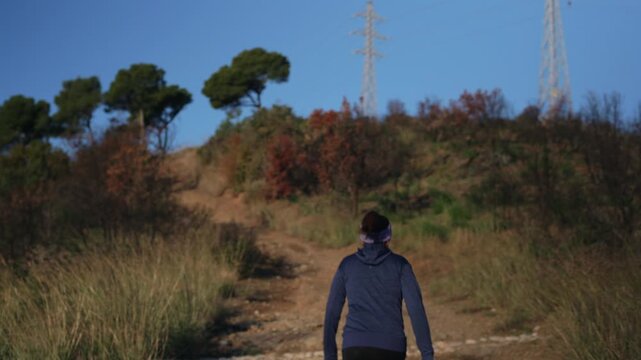 Woman climbs a very steep mountain path