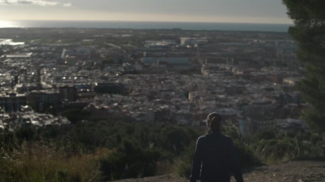 Woman descends the mountain with beautiful views.
