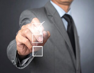 A man in a grey suit marks a check in a box. Focus is on the hand and checkbox
