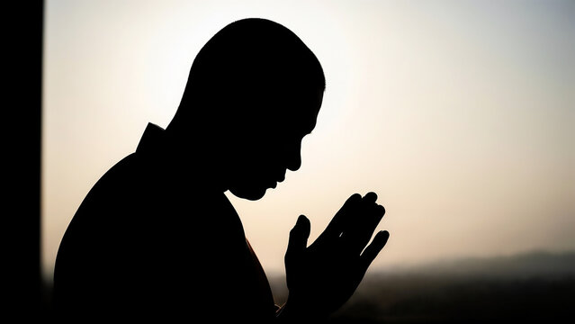 Silhouette of monk praying at sunrise symbolizing inner peace and devotion