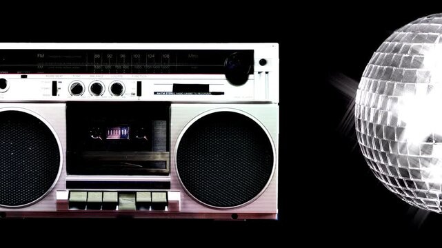 A boombox playing and a disco mirror ball spinning on black, with both items moving off screen in opposite directions to reveal a plain black background.