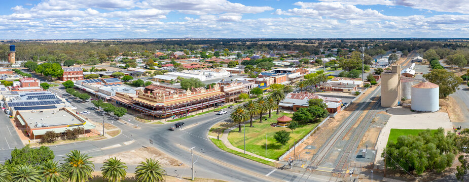 Aerial panorama view of parkland and shops around a large intersection on a regional town