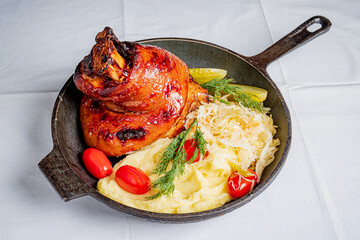 Savor a hearty plate of tender roast pork, creamy mashed potatoes, and bright tomatoes