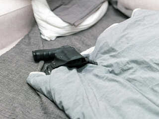 pistol on a bed