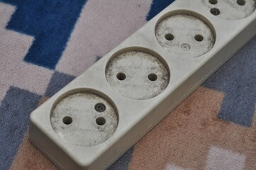 Dirty Electrical Power Strip on Carpet Indoor Safety Concept