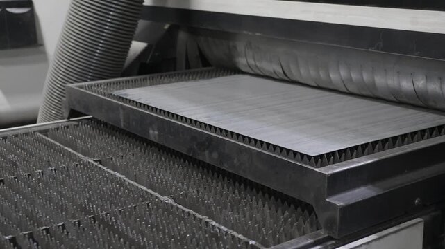 loading a metal sheet into a CNC laser cutting machine