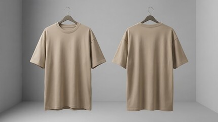 Two beige t shirts on hangers in minimalist gray room