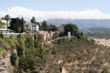 Fototapeta premium Cliffside view with buildings and greenery.. Málaga, Spain