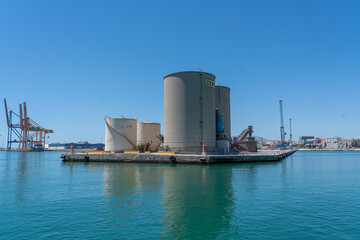 Fototapeta premium Industrial structures on water with clear blue sky.. Málaga, Spain