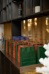 Colorful New Year gift bags with festive wrapping, bright decorations and holiday presents, cheerful seasonal celebration atmosphere.