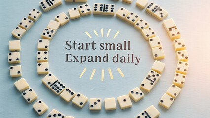 Dominoes forming a spiral arrangement with motivational text