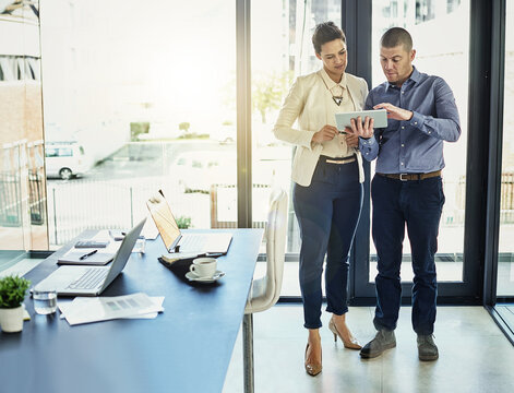 Businessman, woman or reading with tablet in office, timesheet audit or staff attendance confirmation. Teamwork, tech or payroll manager with employee record review, check accuracy or verify overtime