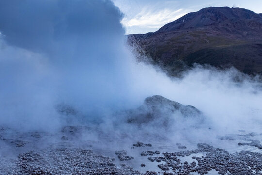 Geyser erupting at El Tatio in the Antofagasta Region of Chile before sunset