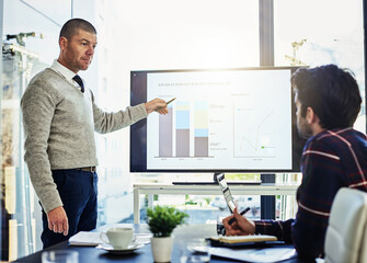 Businessman, meeting and boardroom with screen for presentation, statistics or analytics in office. Man, analyst or speaker with display, graph or chart for company growth or revenue in workplace