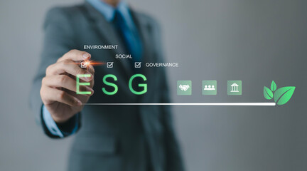 Business professionals are using digital interfaces that showcase ESG concepts, sustainability, energy, renewable energy, environment, sustainability analytics, and green investment.
