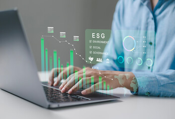 Business professionals are using digital interfaces that showcase ESG concepts, sustainability, energy, renewable energy, environment, sustainability analytics, and green investment.
