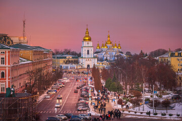 View of Kyiv after sunset, pink winter sky glowing above the city 