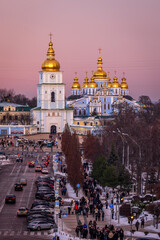 View of Kyiv after sunset, pink winter sky glowing above the city 