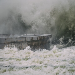 STORM AT SEA - Powerful waves of foaming sea water at the pier