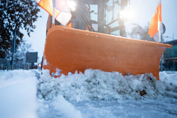 Snow plow clearing road surface during winter