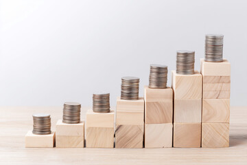 Wooden Blocks and Coins Forming Upward Steps for Income Growth