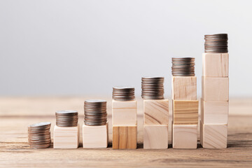 Wooden Blocks with Coins Forming Steps to Represent Financial Growth
