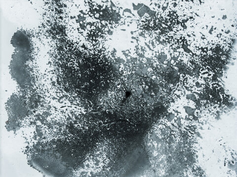 Aerial view of the serene, frozen expanse of Lake Galve, its icy surface etched with intricate patterns, a stark contrast against the winter sky, Trakai, Lithuania.