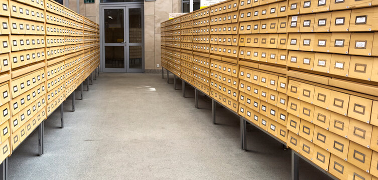 Archive interior with rows of vintage boxes and document storage in a museum or library setting.