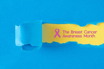 torn paper background with breast cancer awareness month text