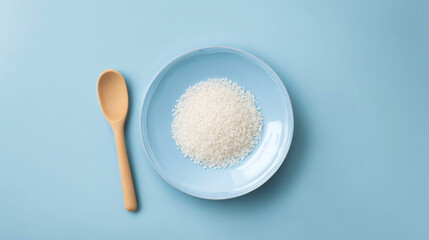 Conceptual Image of Grain of Rice on Plate with Wooden Spoon