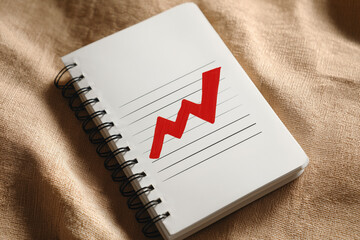 Notebook With Rising Graph Icon Illustrating Investment Trends