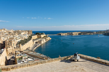 A scenic View of the Three Cities of Malta across the Grand Harbour in Valletta, taken from the Upper Barrakka Gardens.