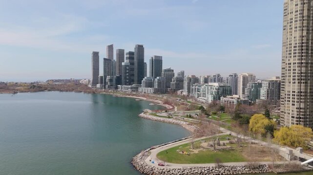 Aerial Flyover Of Lake Ontario And Parklawn Neighbourhood Skyline Near Downtown Toronto, Canada.