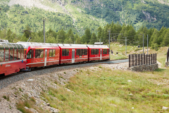 The famous red panoramic train bernina express get over the high bernina pass (2328 m). Graubunden, Switzerland