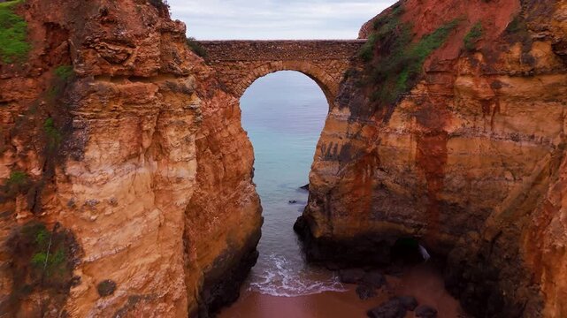 Aerial View of Ponte do Antigo Forte do Pinhao at Praia dos Estudantes in Lagos Algarve Portugal. 