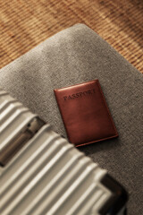 Closed  suitcase with passport, travel documents and luggage ready for departure