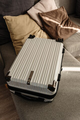 Hard-shell suitcase  in modern living room, travel luggage ready for departure
