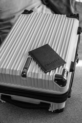 Closed  suitcase with passport, travel documents and luggage ready for departure