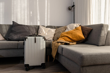 Hard-shell suitcase  in modern living room, travel luggage ready for departure