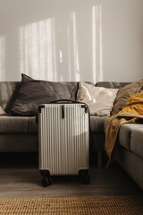 Hard-shell suitcase  in modern living room, travel luggage ready for departure