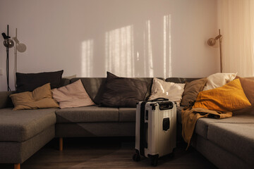 Hard-shell suitcase  in modern living room, travel luggage ready for departure