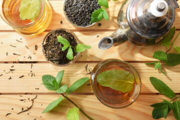Green tea on a wooden table with ingredients top view